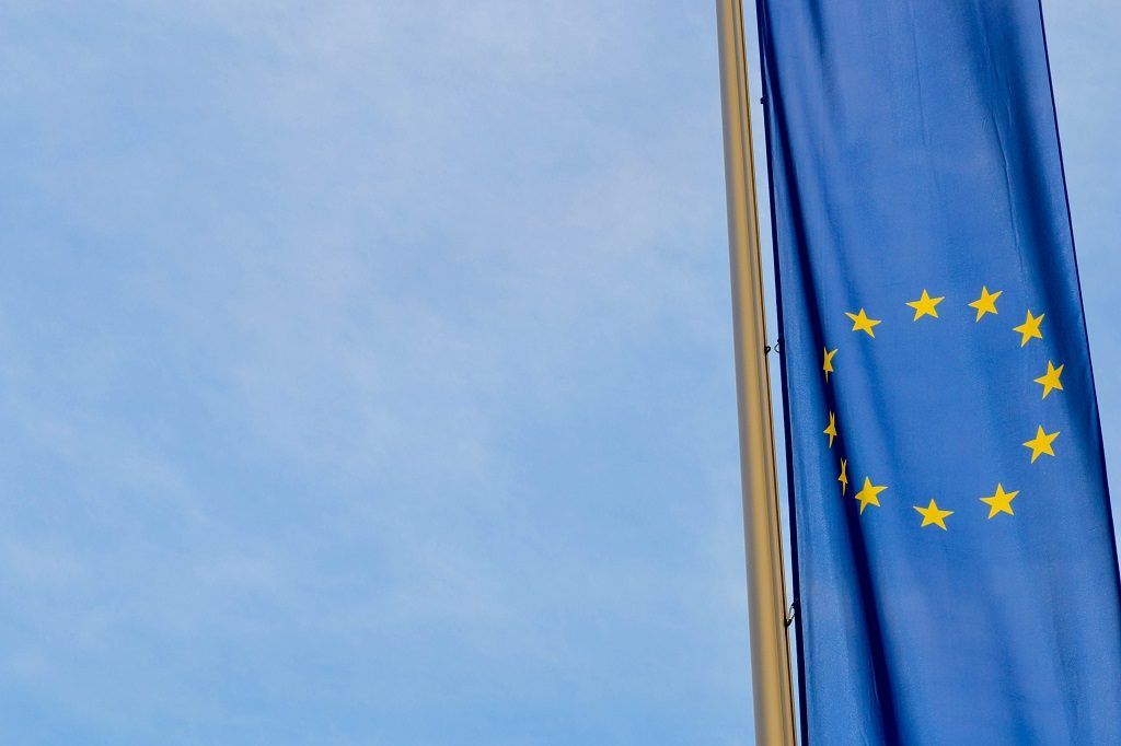 EU flags flying against a blue sky